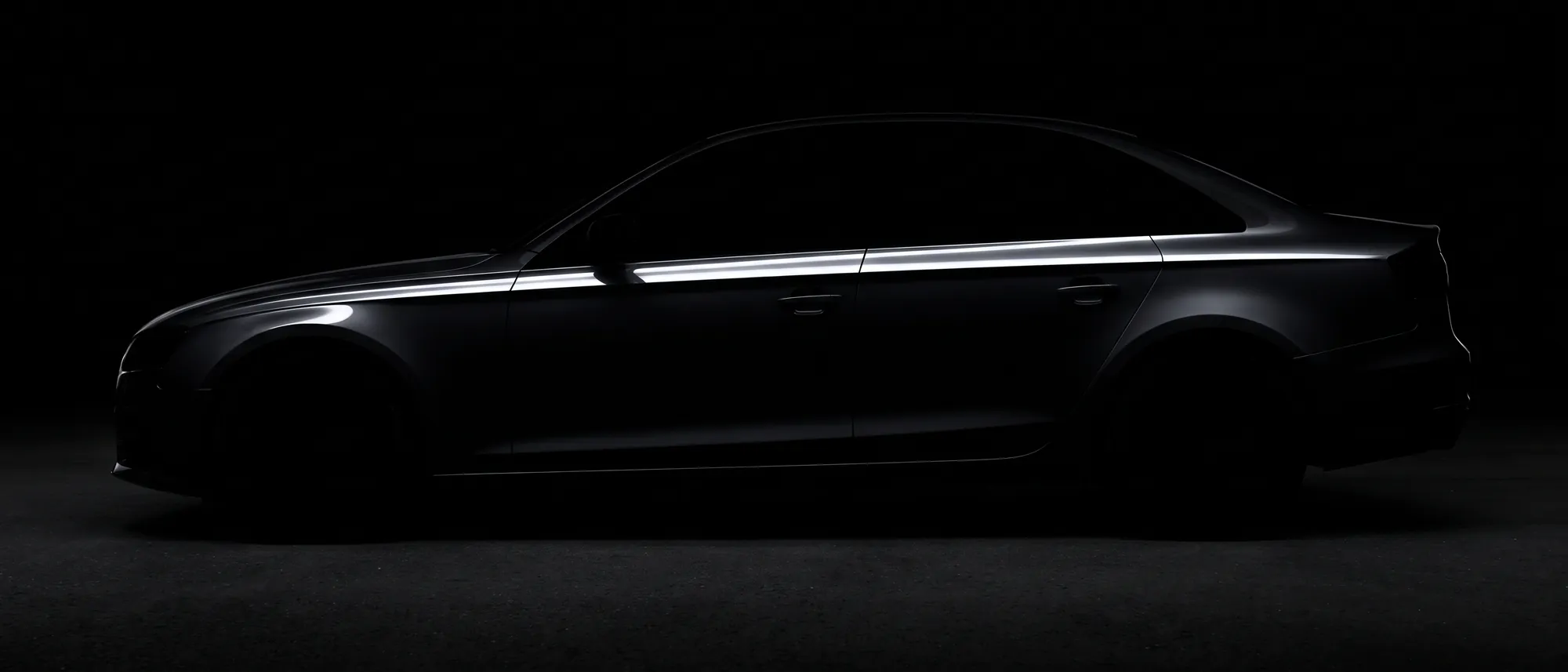 A dark sedan in profile, close to silhouette, one hard highlight along the shoulder line